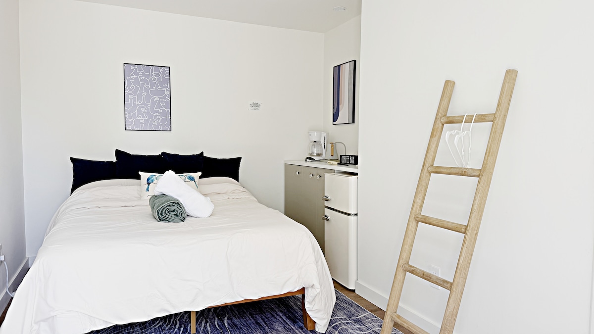 Private suite bedroom with coffee bar and mini-fridge